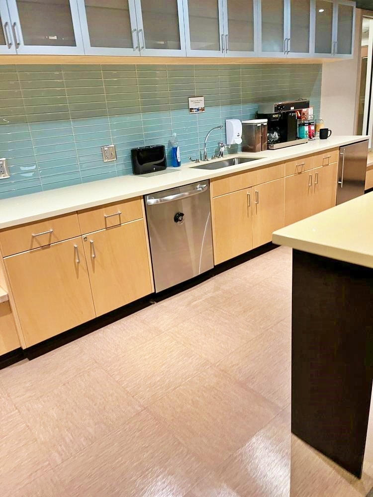 Spotless commercial kitchen break room with clean countertops and appliances
